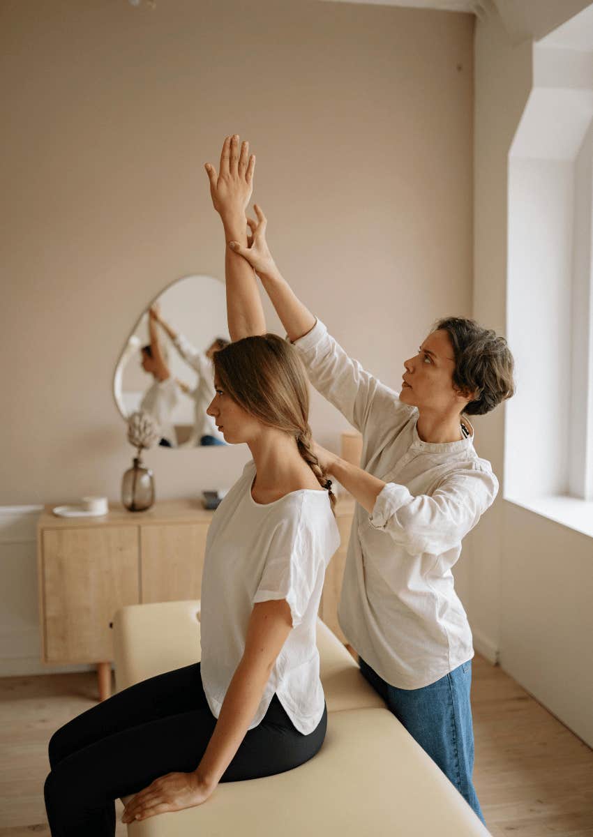 young woman sitting on a massage table