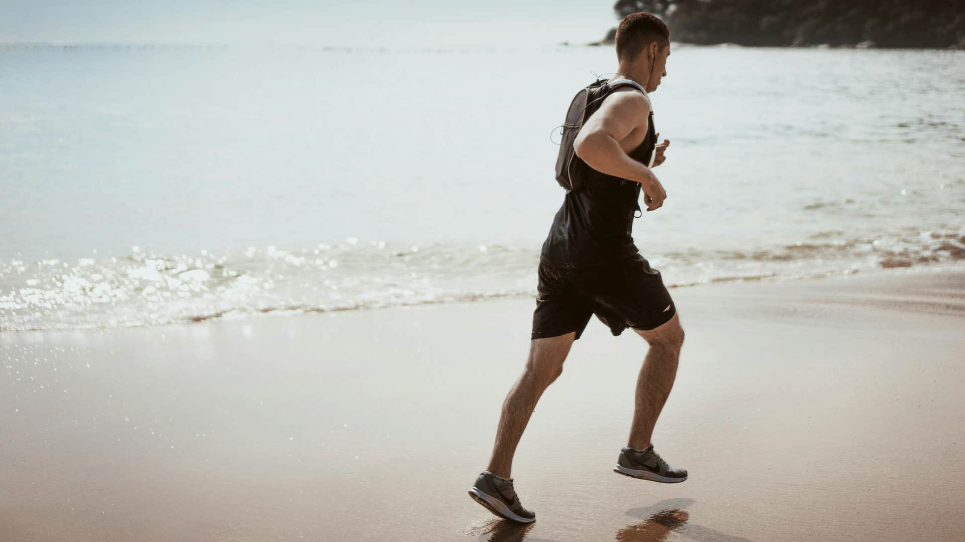 man jogging on the shoreline