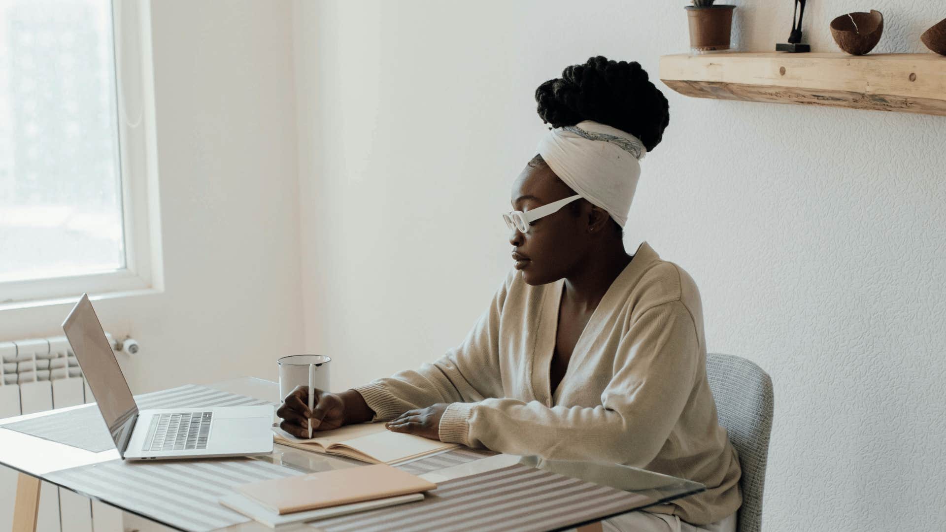 woman journaling in a dining room table