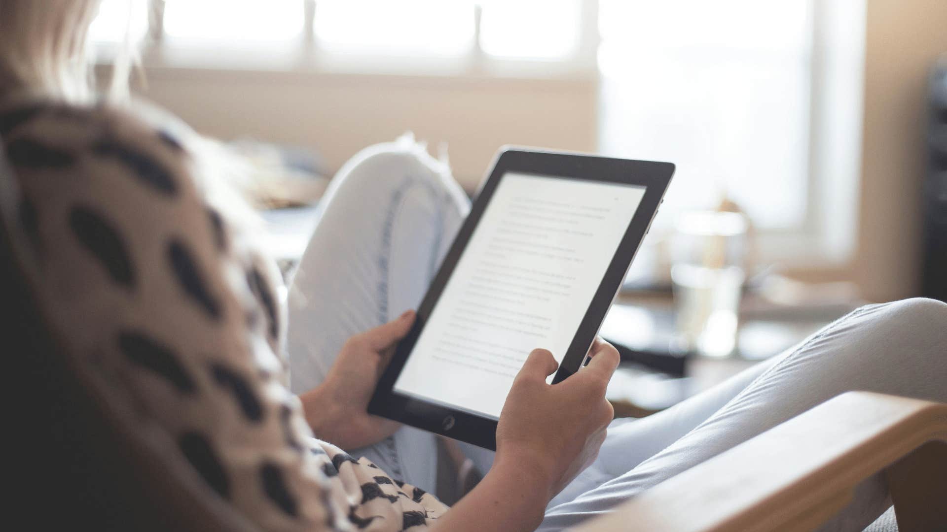 teenager reading on an e-reader