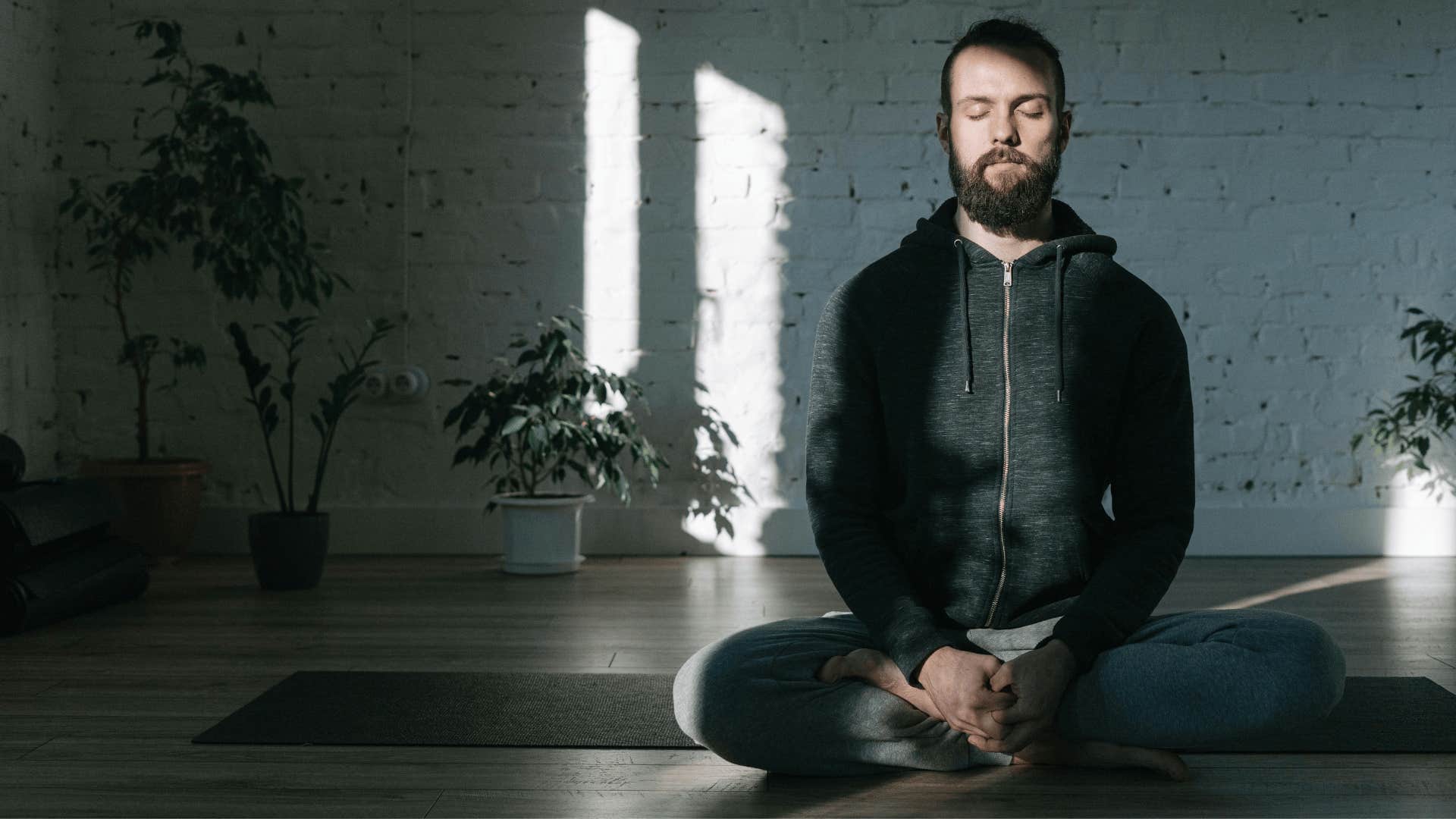 man meditating on a yoga mat