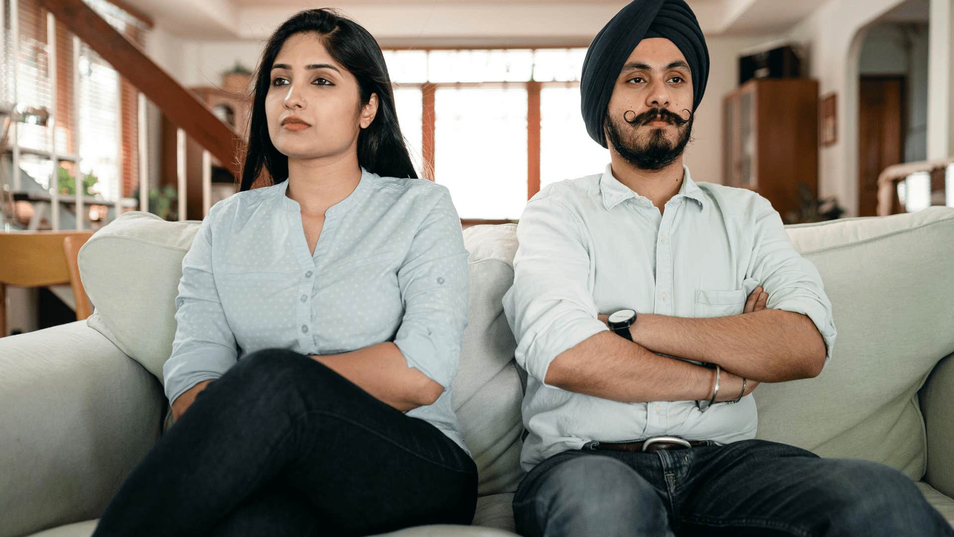 serious couple sitting next to each other