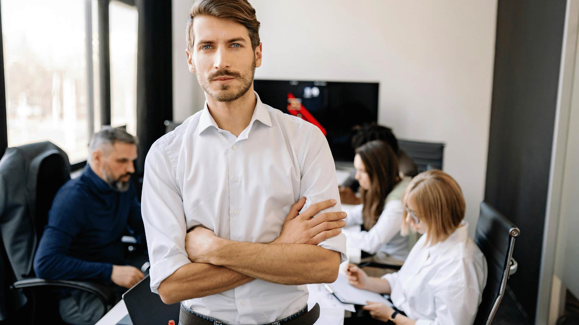 confident man standing in a meeting room