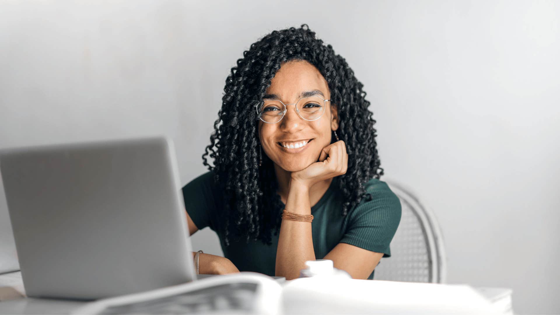 smiling young woman with an open laptop