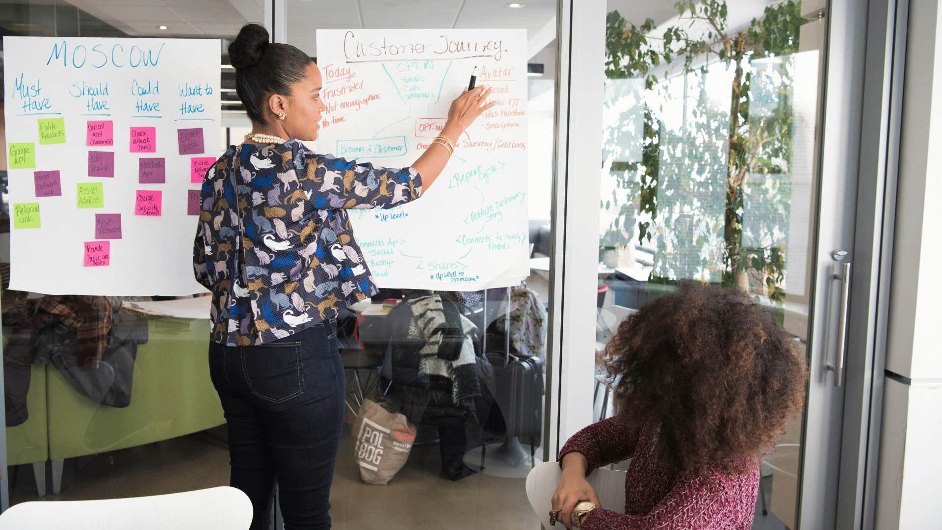 woman presenting and problem solving to coworker