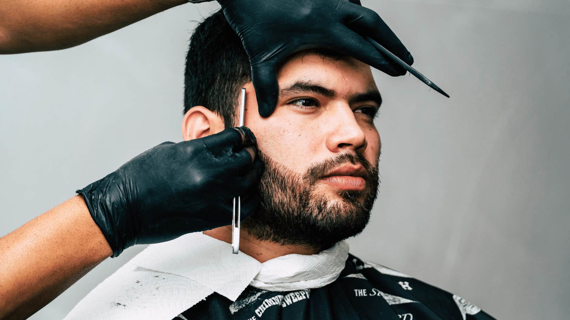 young man sitting in a barber's chair