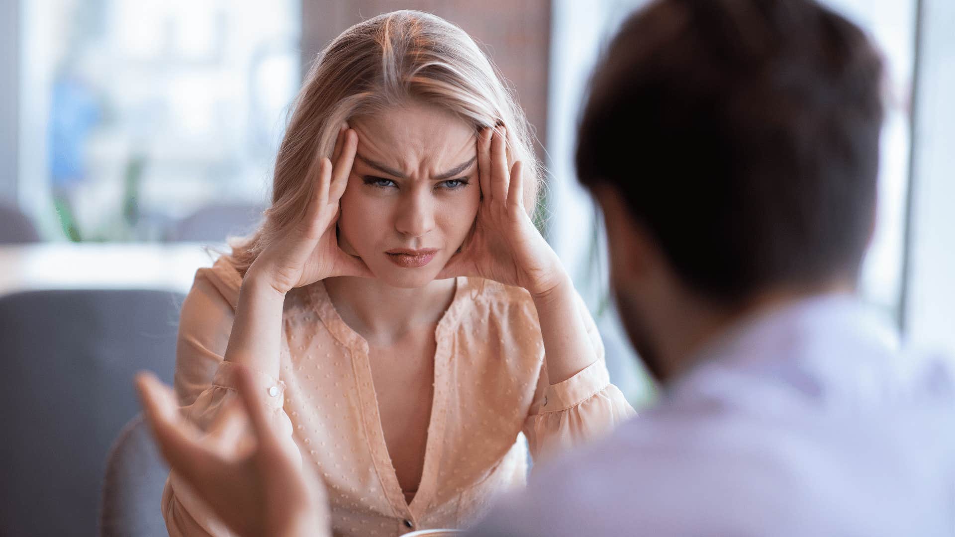 unhappy young woman staring at man