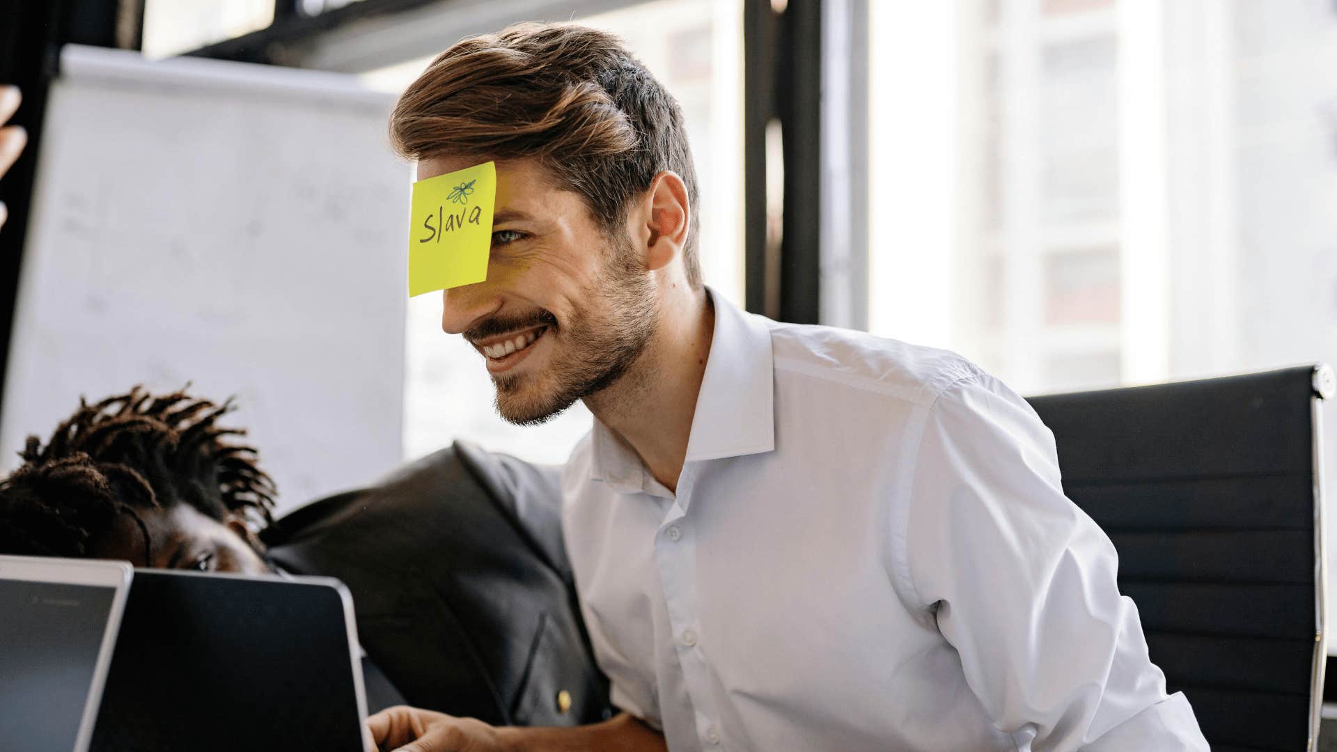 playful businessman with a sticky note on his forehead