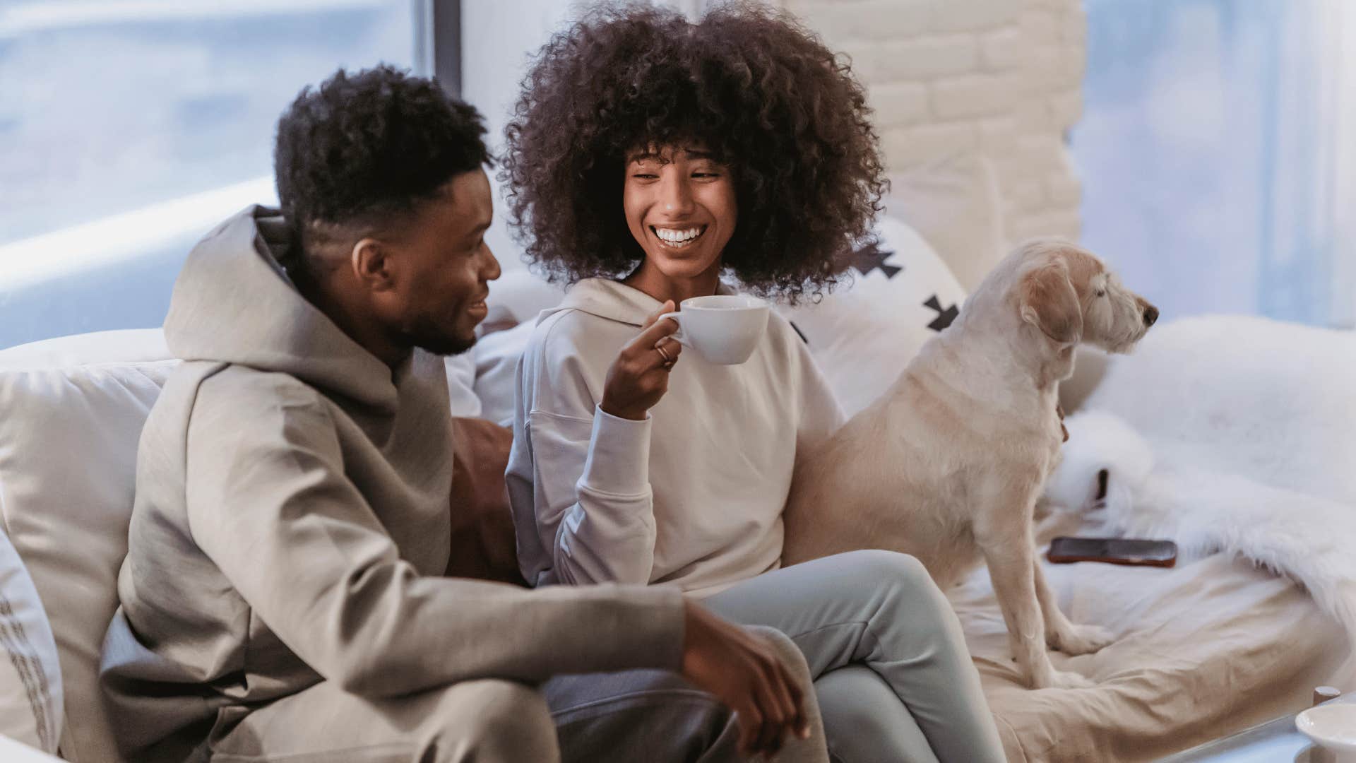 couple having a conversation while sitting on a couch