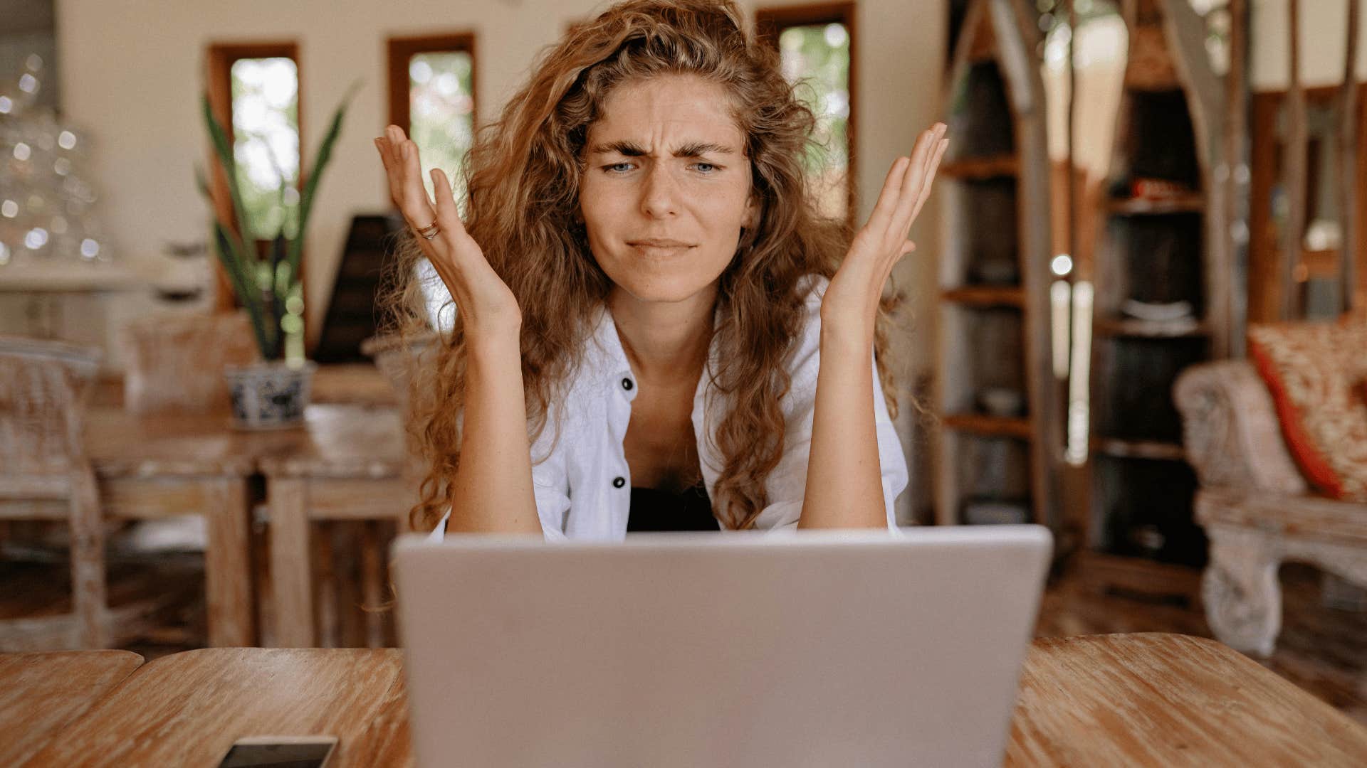 woman showing frustration at laptop screen