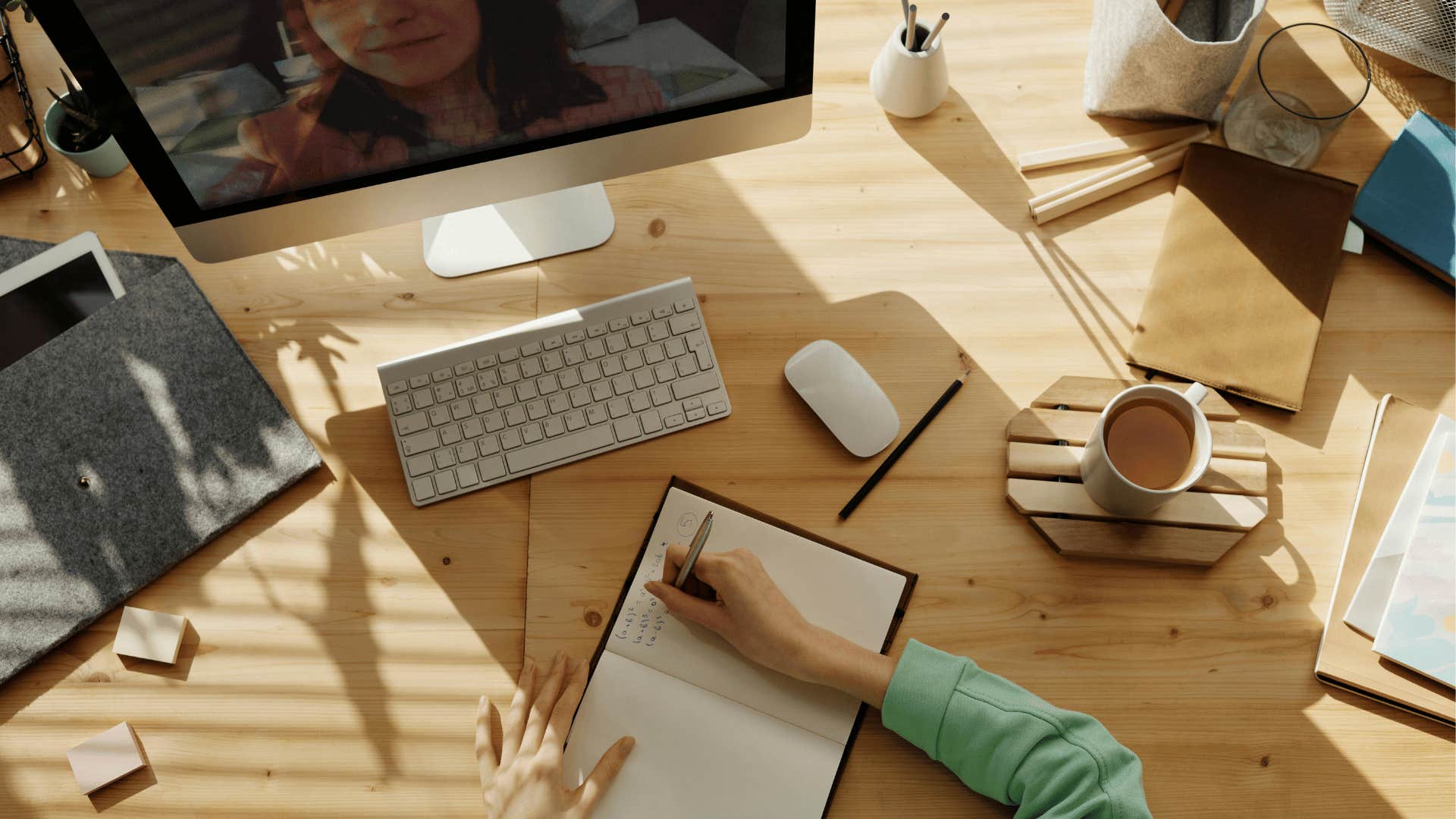 woman watching video and taking notes