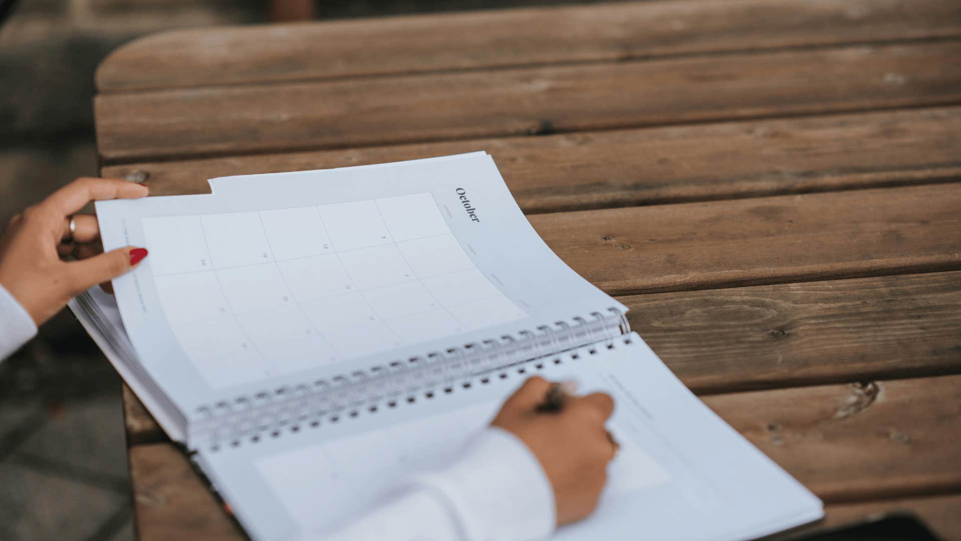 woman writing in a planner