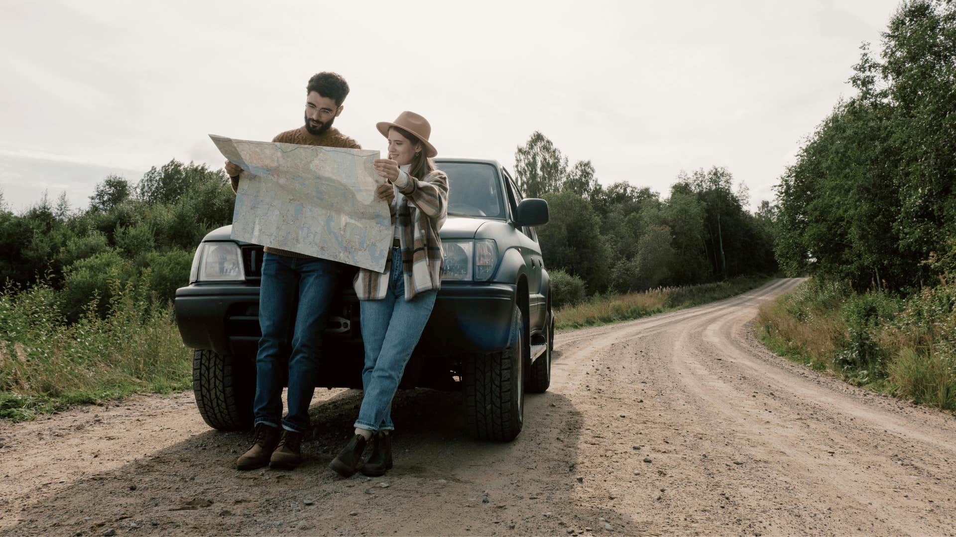 couple on a trip looking at a map together