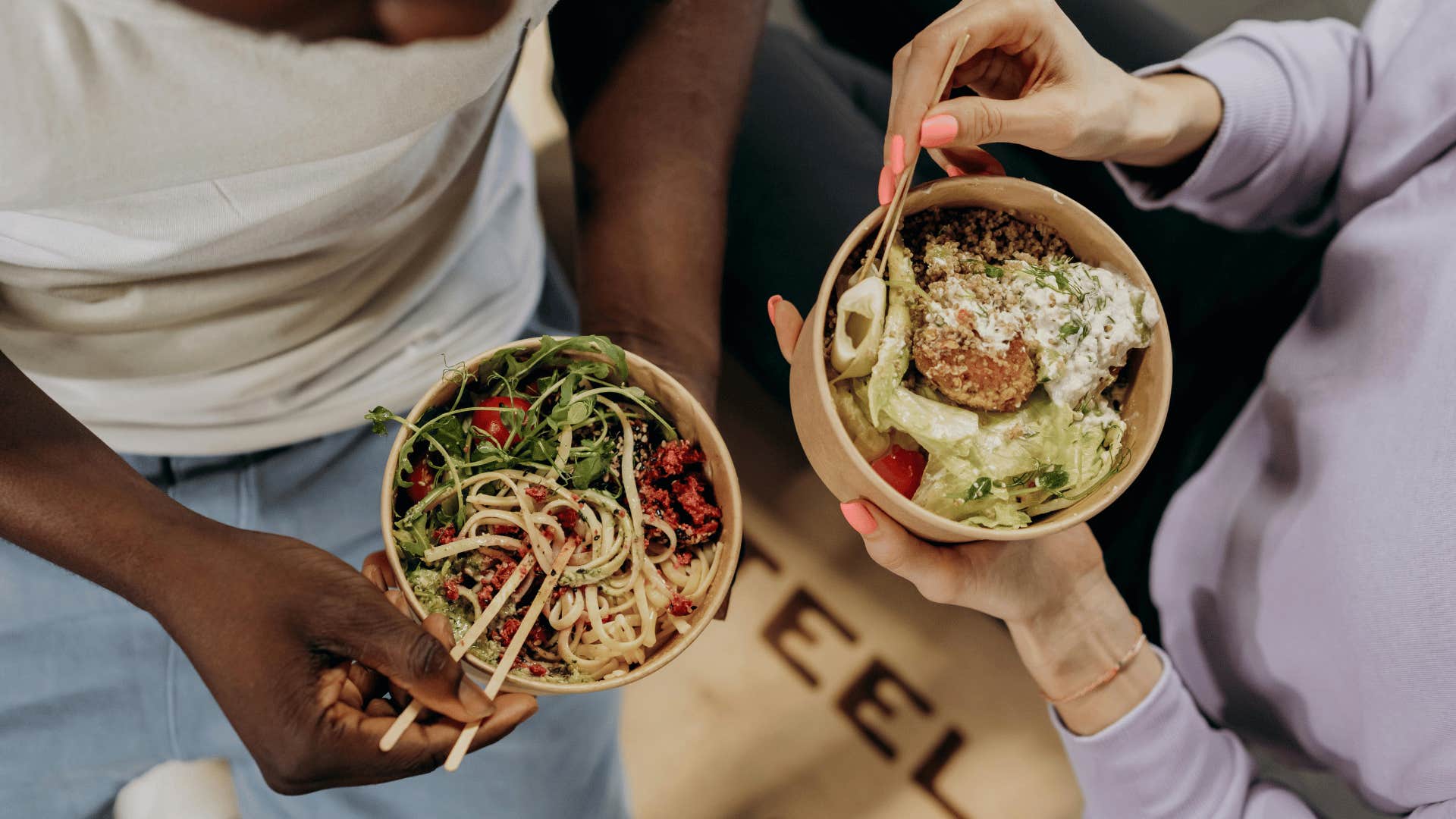 man and woman eating healthy meals