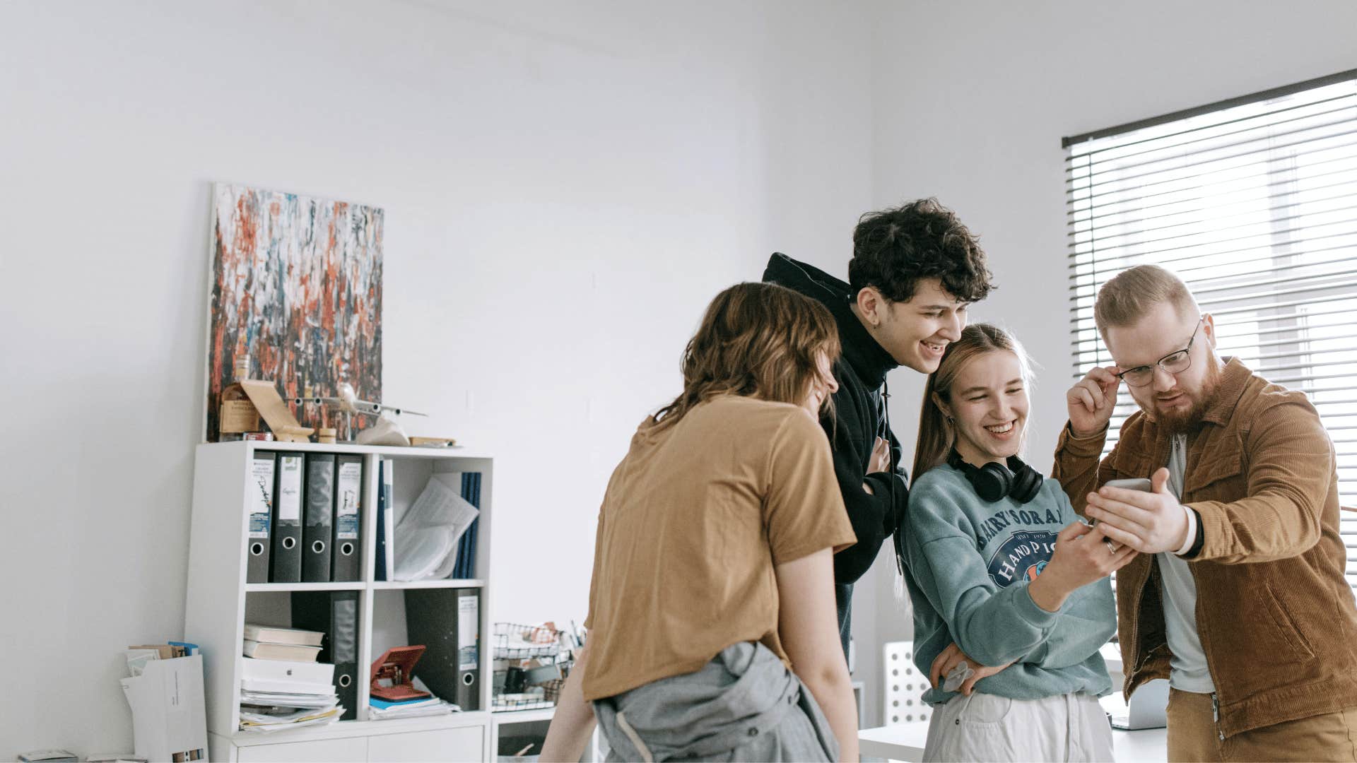 group of friends looking at a phone together