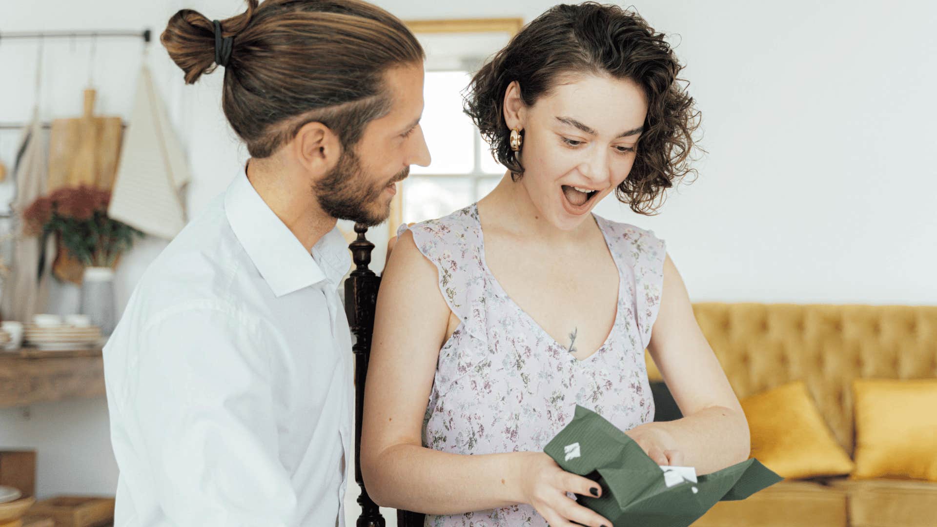 man giving a gift to a surprised woman