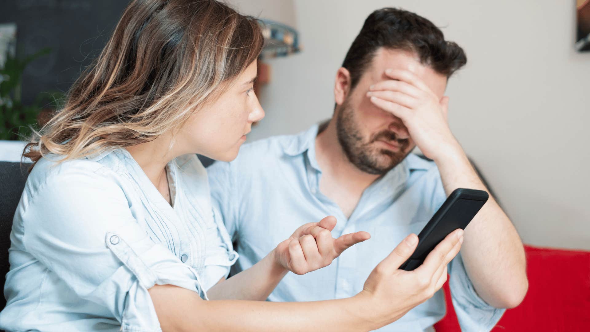 woman showing phone to an exhausted man