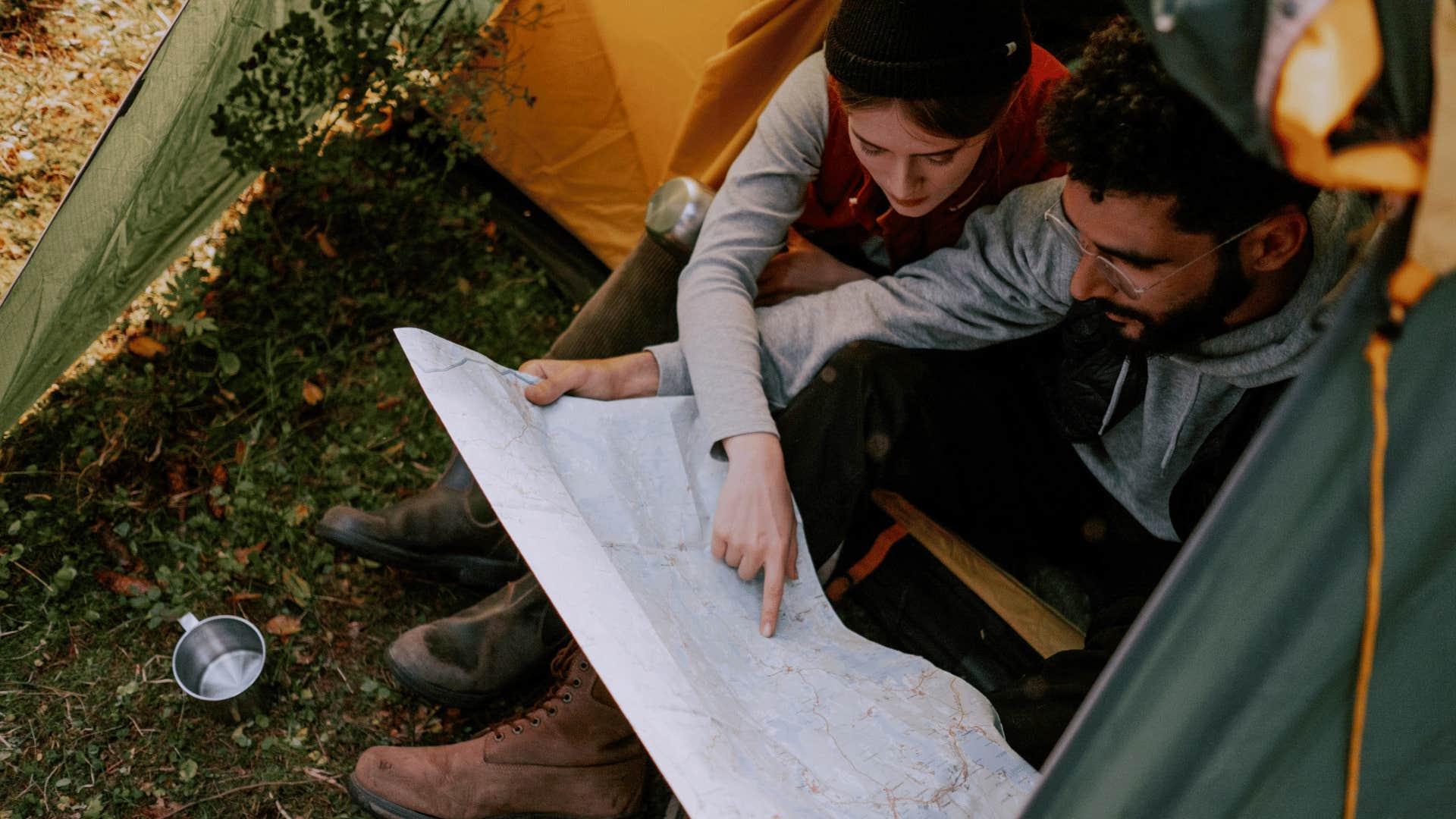 couple looking at a man on a camping trip