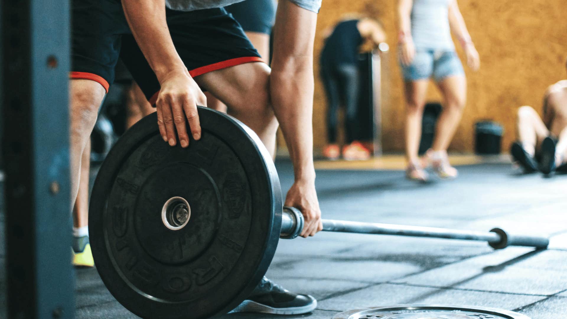 man loading a weight onto a bar