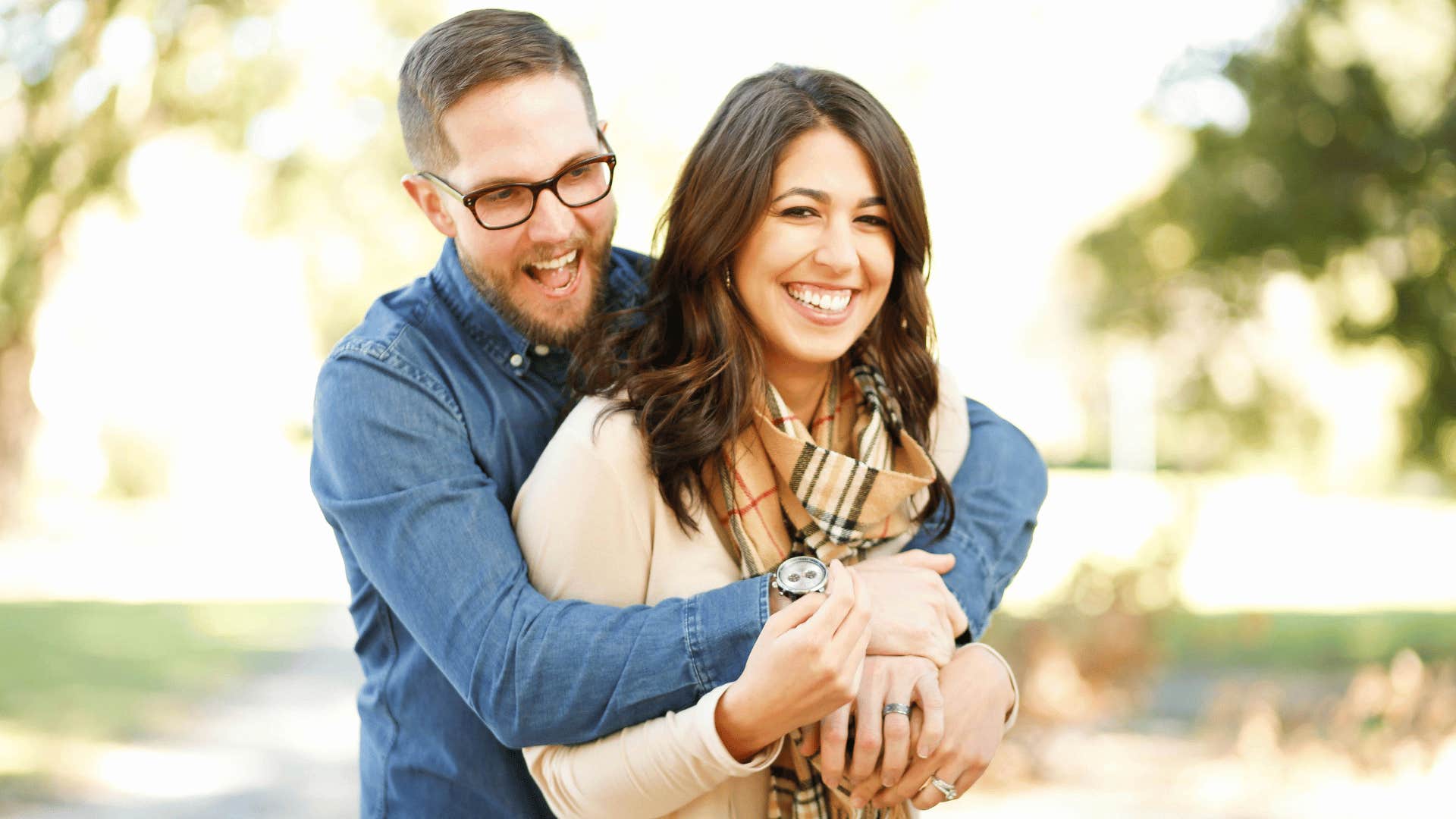 man hugging a woman from behind