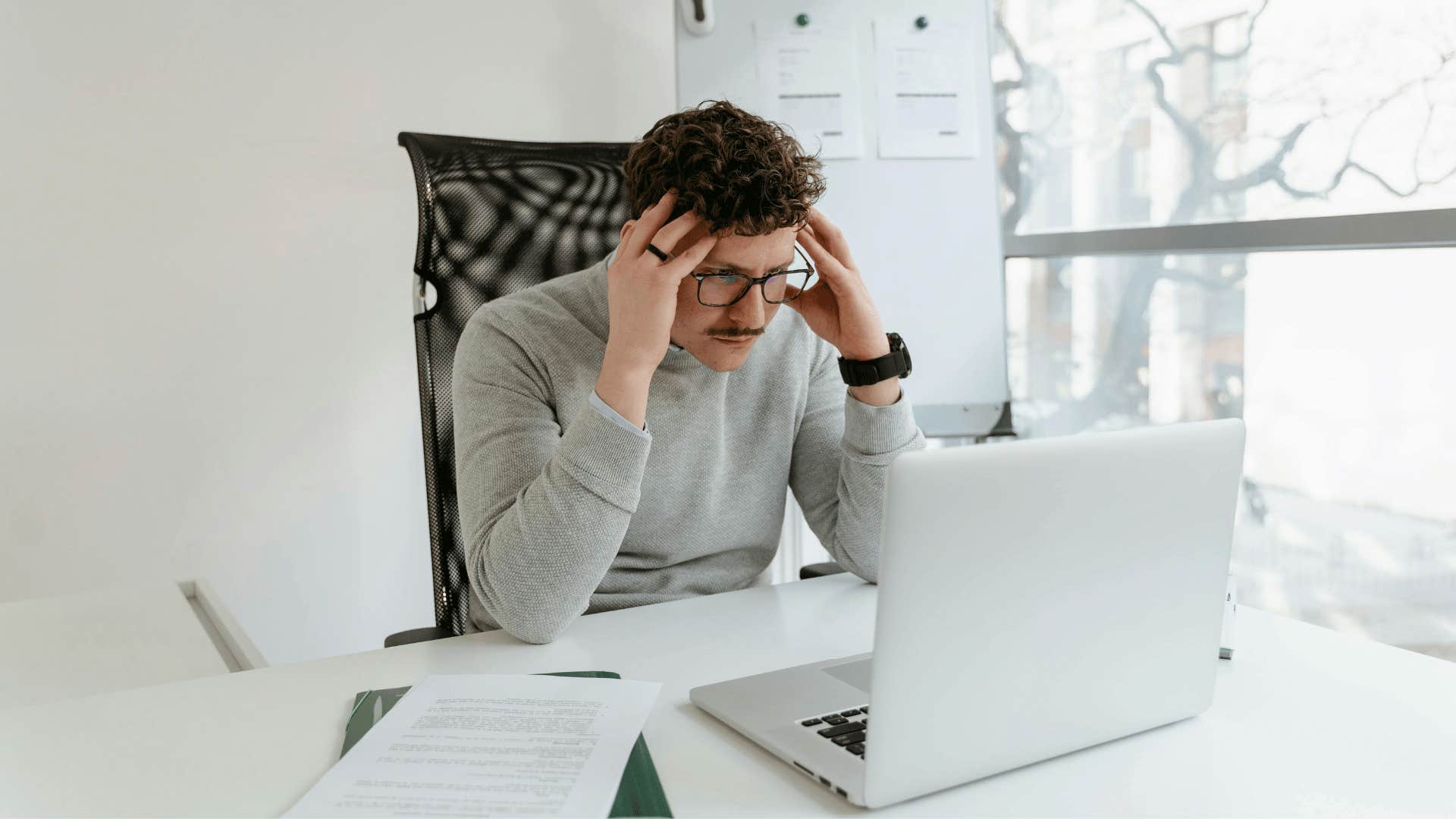 man holding his temples in frustration