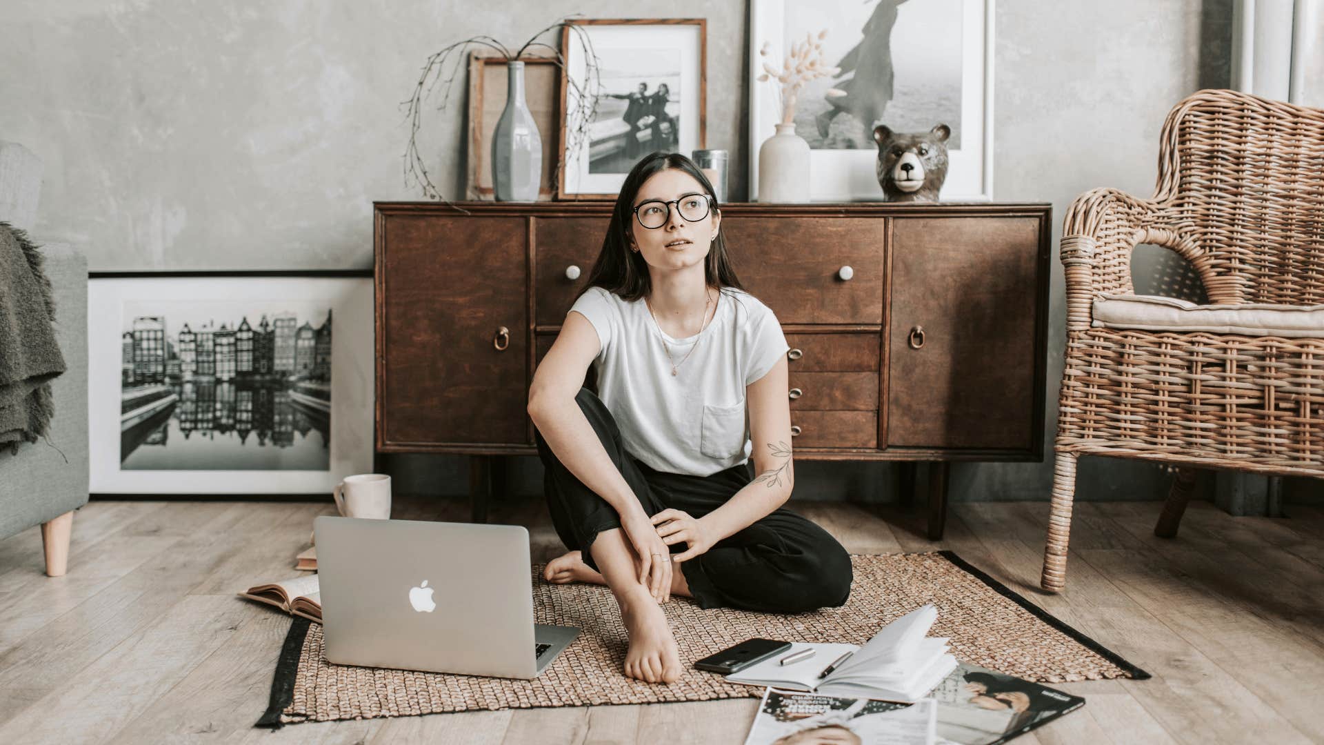 thoughtful young woman sitting on the floor