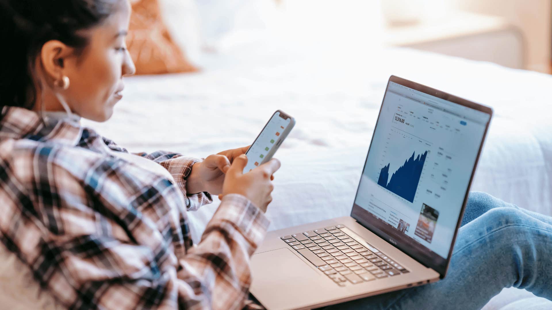 young woman researching investments on laptop