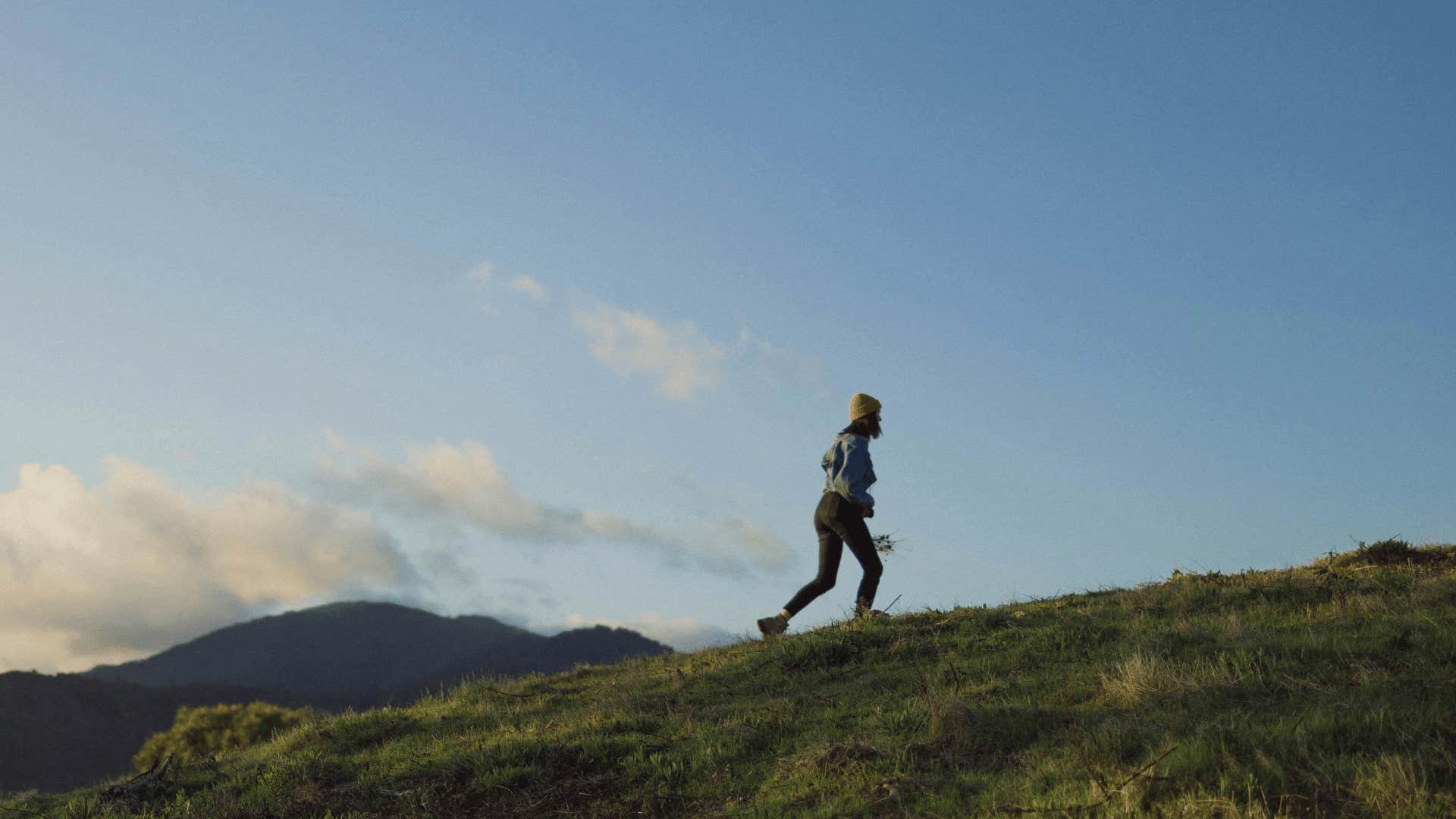 woman running up a hill