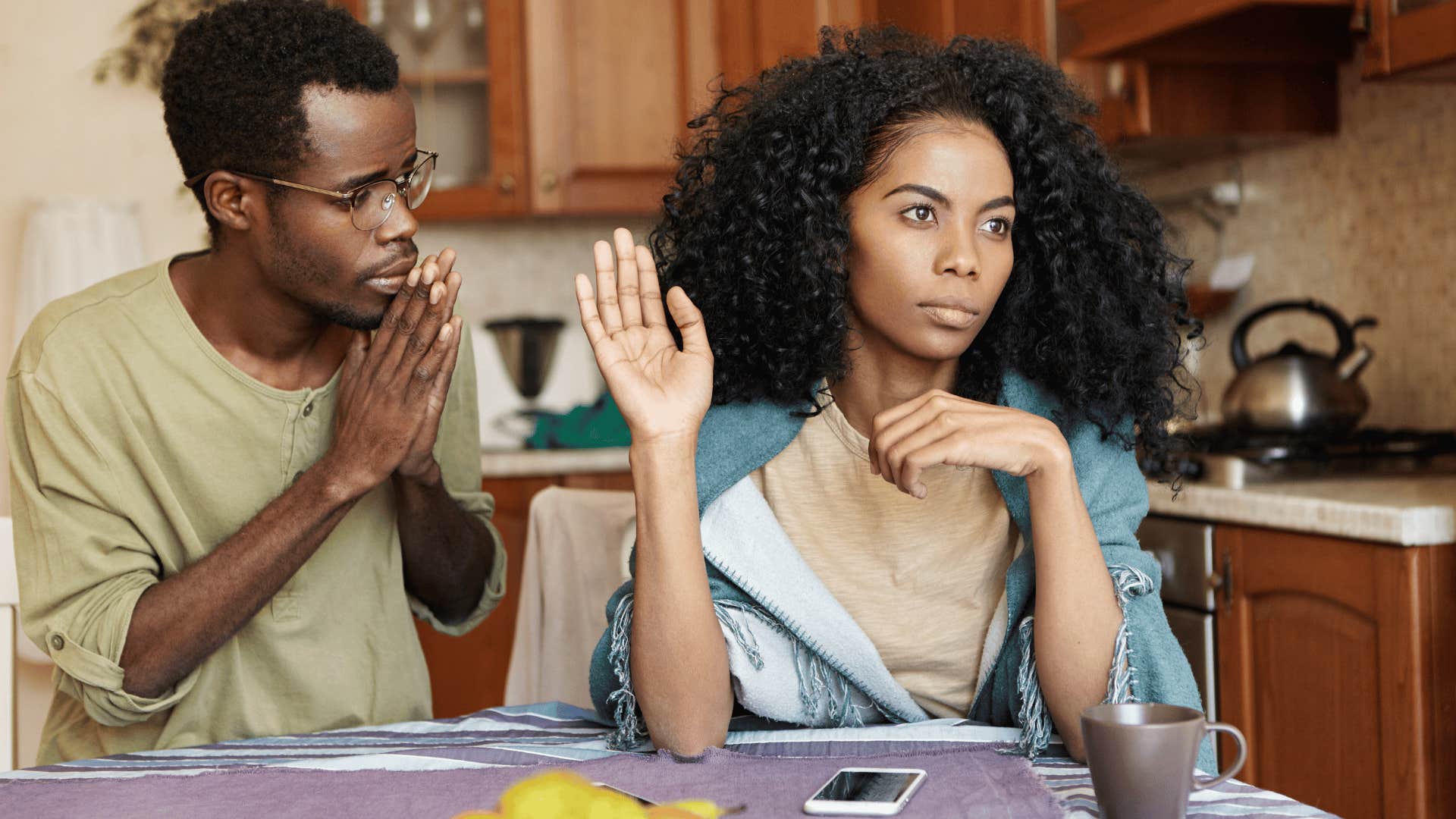 man begging woman who is ignoring him