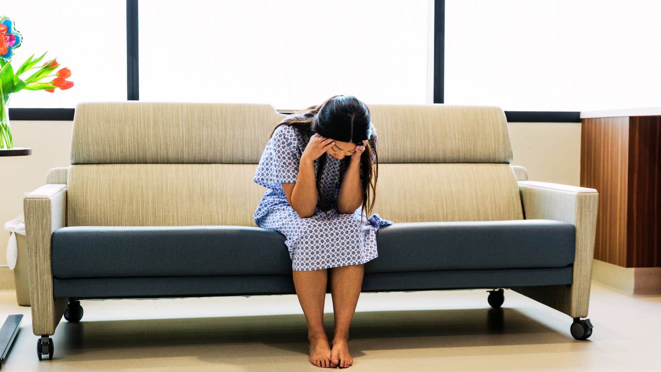 Woman in hospital gown after having abortion. 