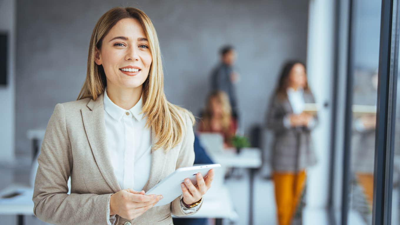 businesswoman with work meeting behind her