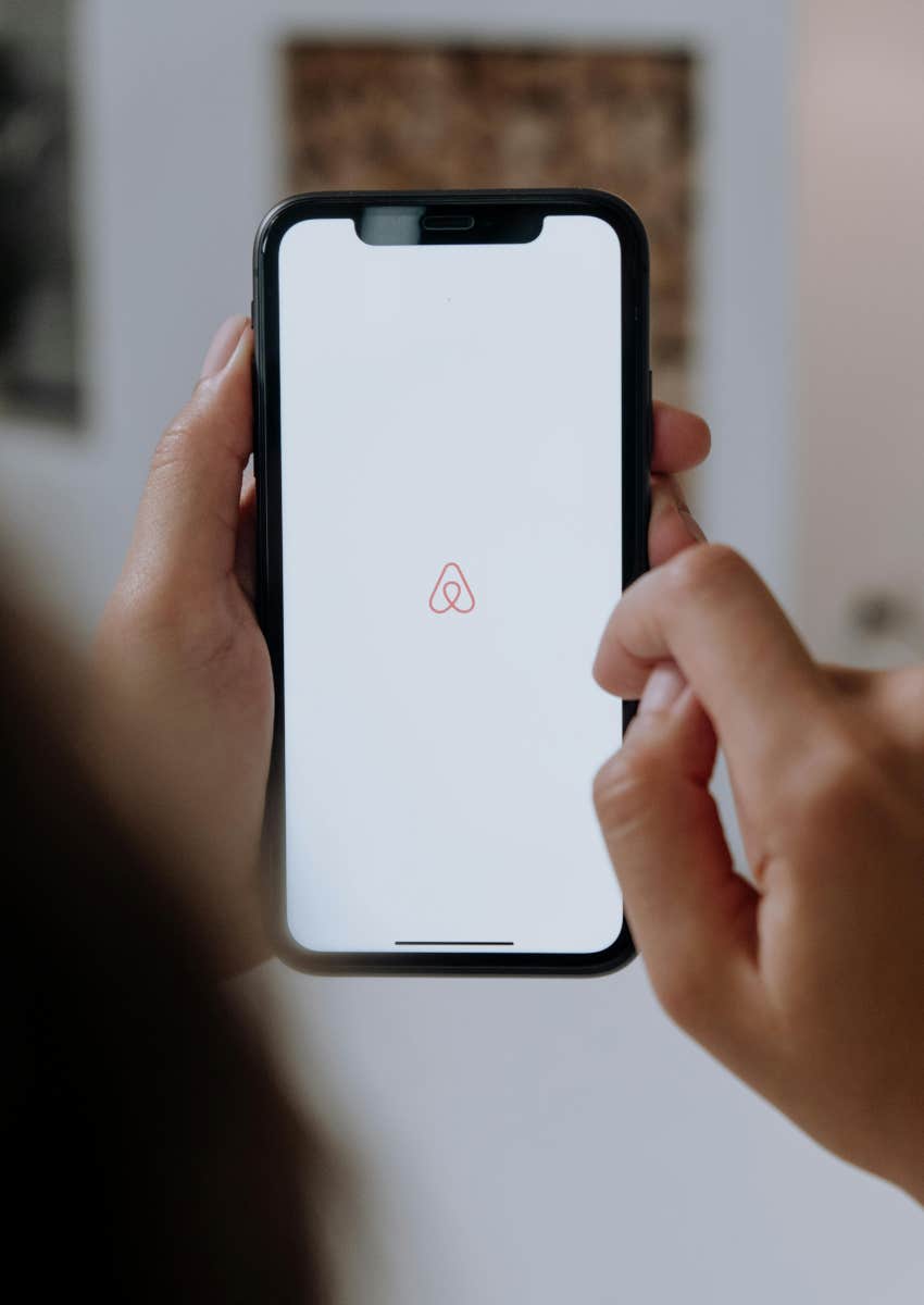 someone opening Airbnb app on phone