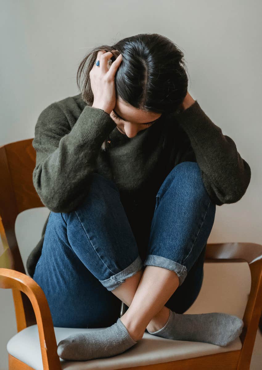 anxious woman in a green sweater