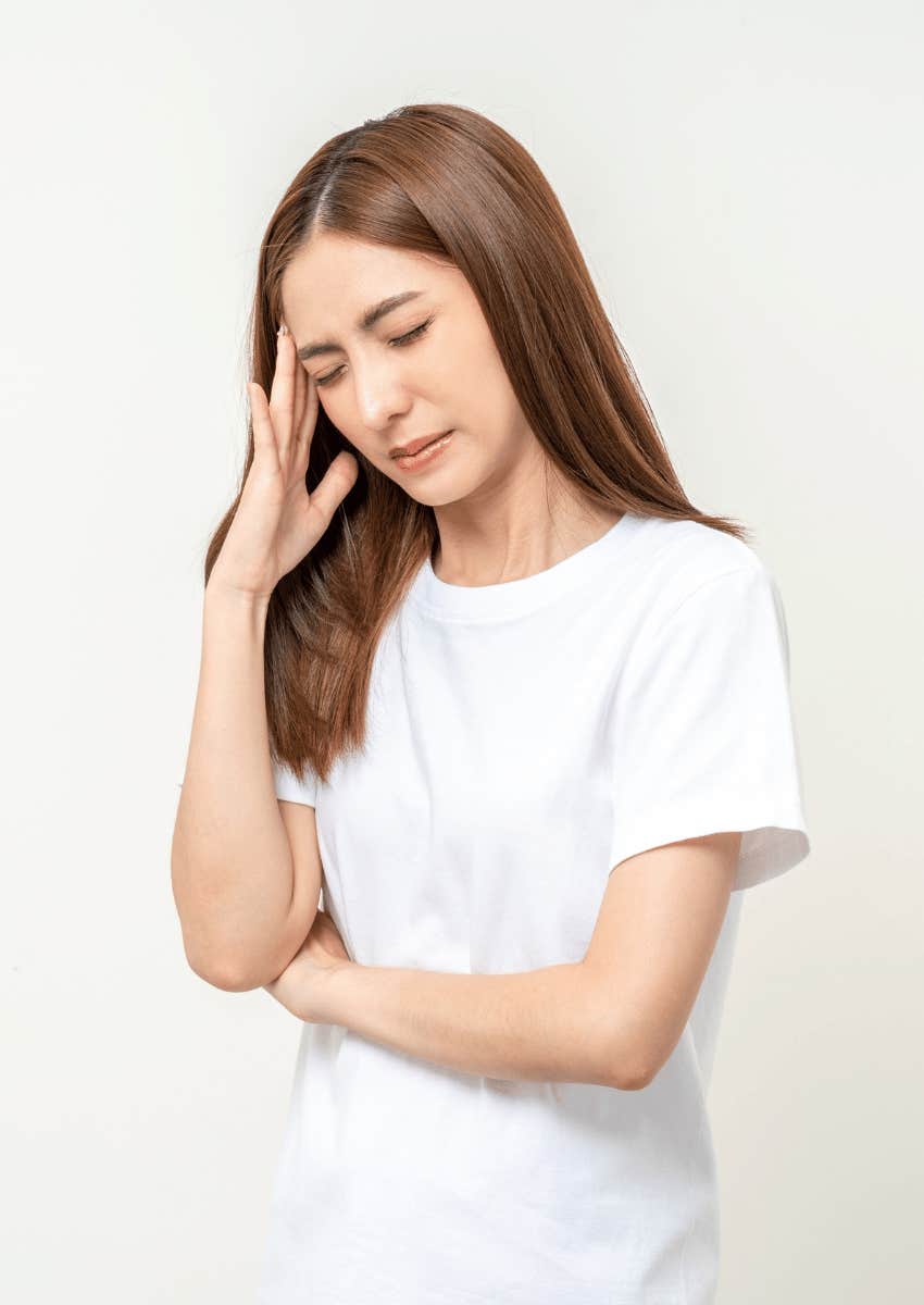 anxious woman rubbing her temple