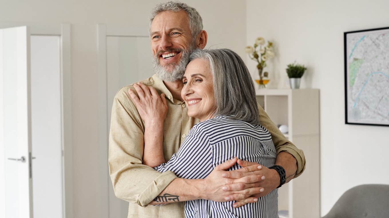 older couple hugging in a living room