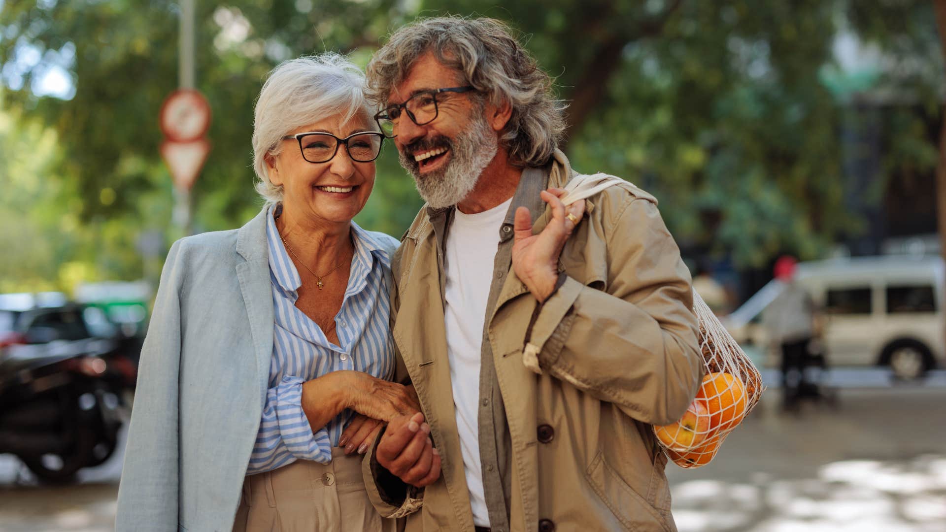 Couple smiling and walking together outside.