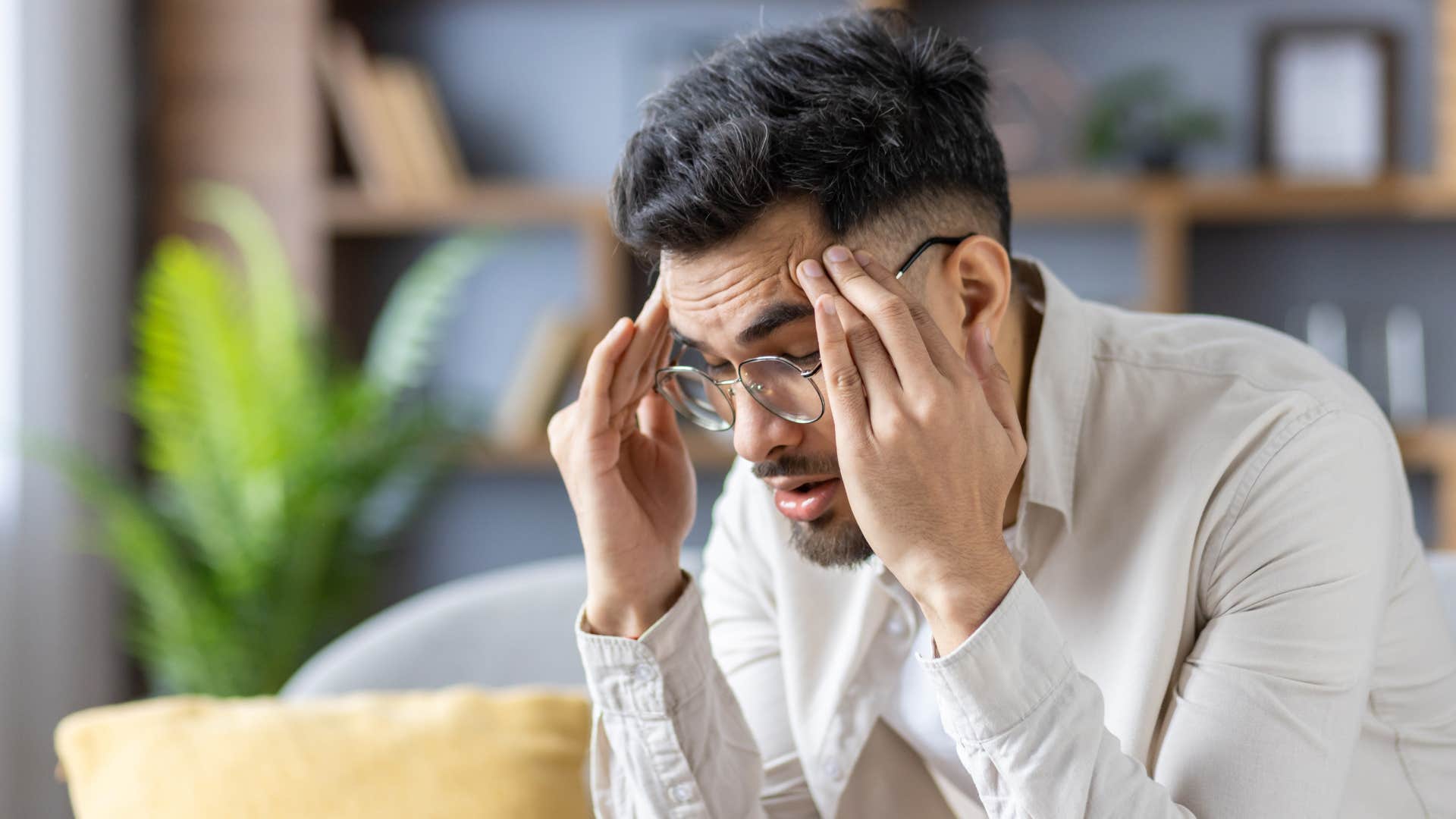 Man looking unfocused at his desk.