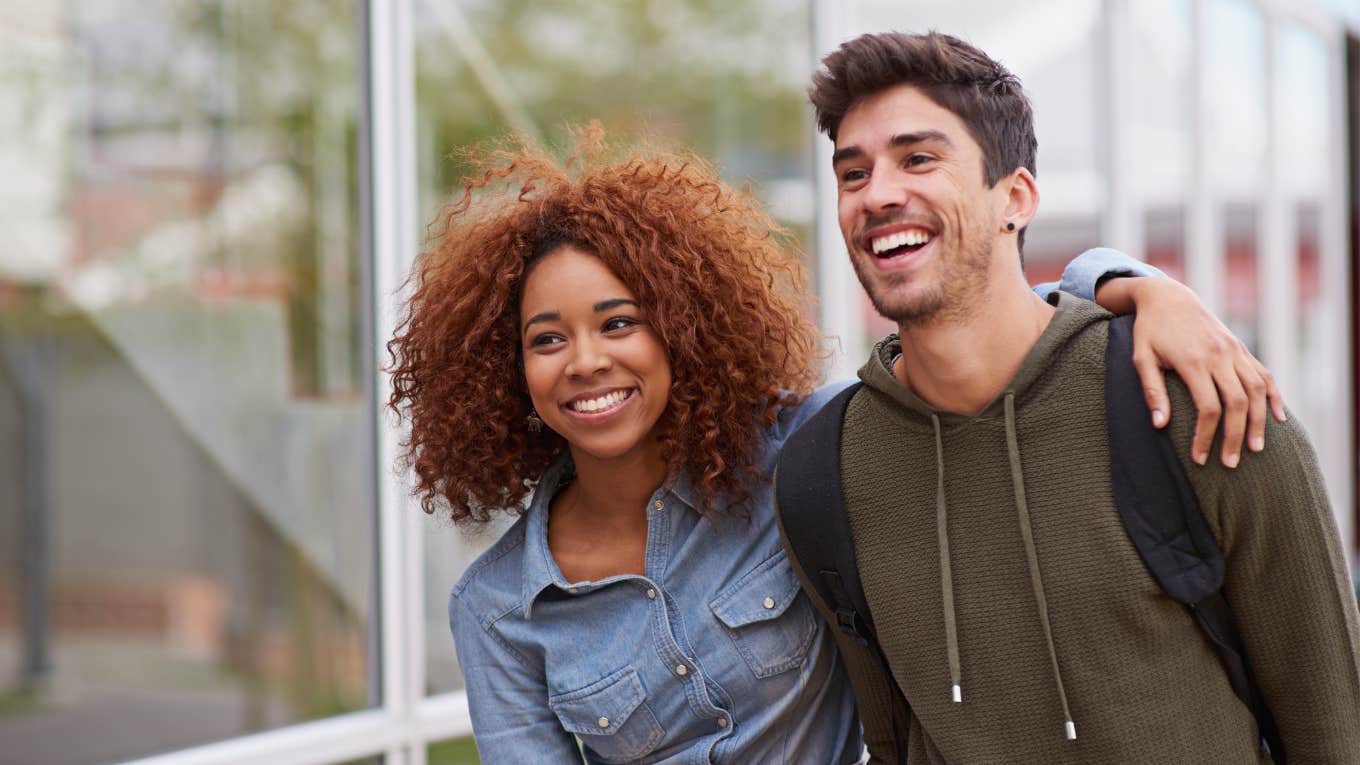 Woman uses subtle body language hack to enchant a guy.