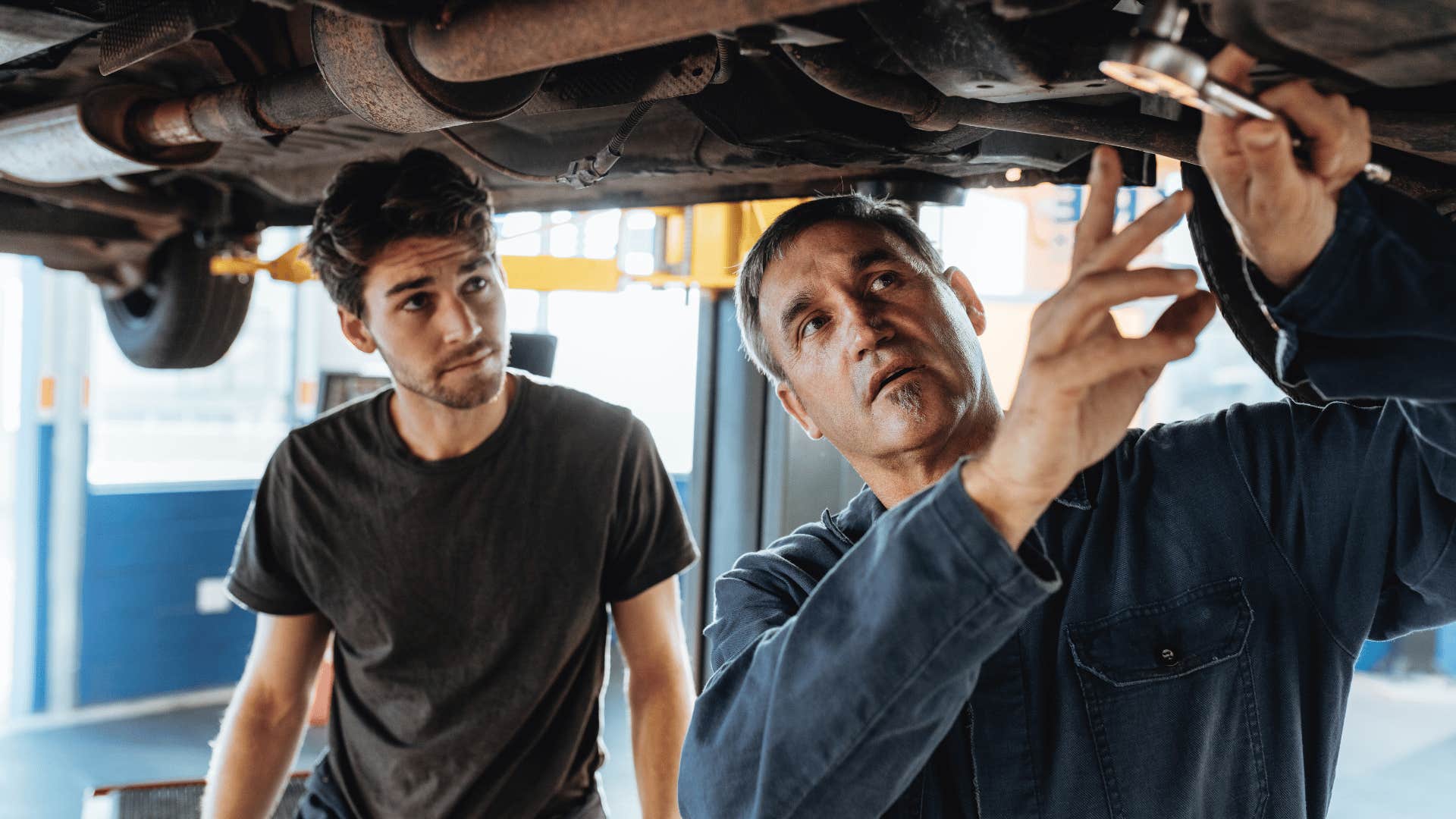 two men working on car