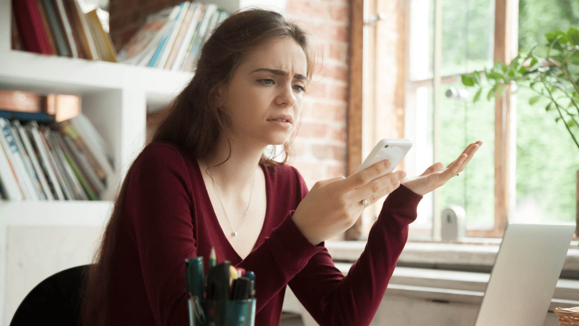 woman frowning at her phone