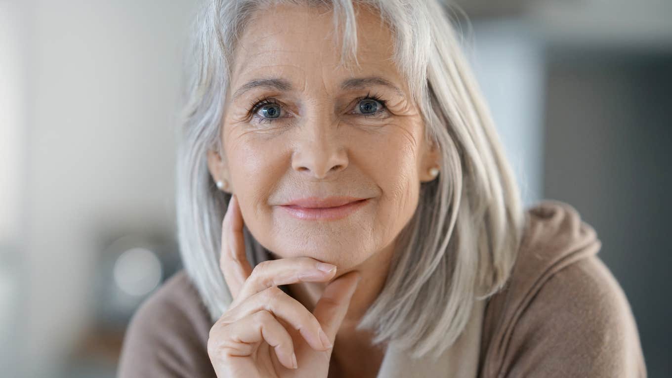 older boomer woman thinking and smiling