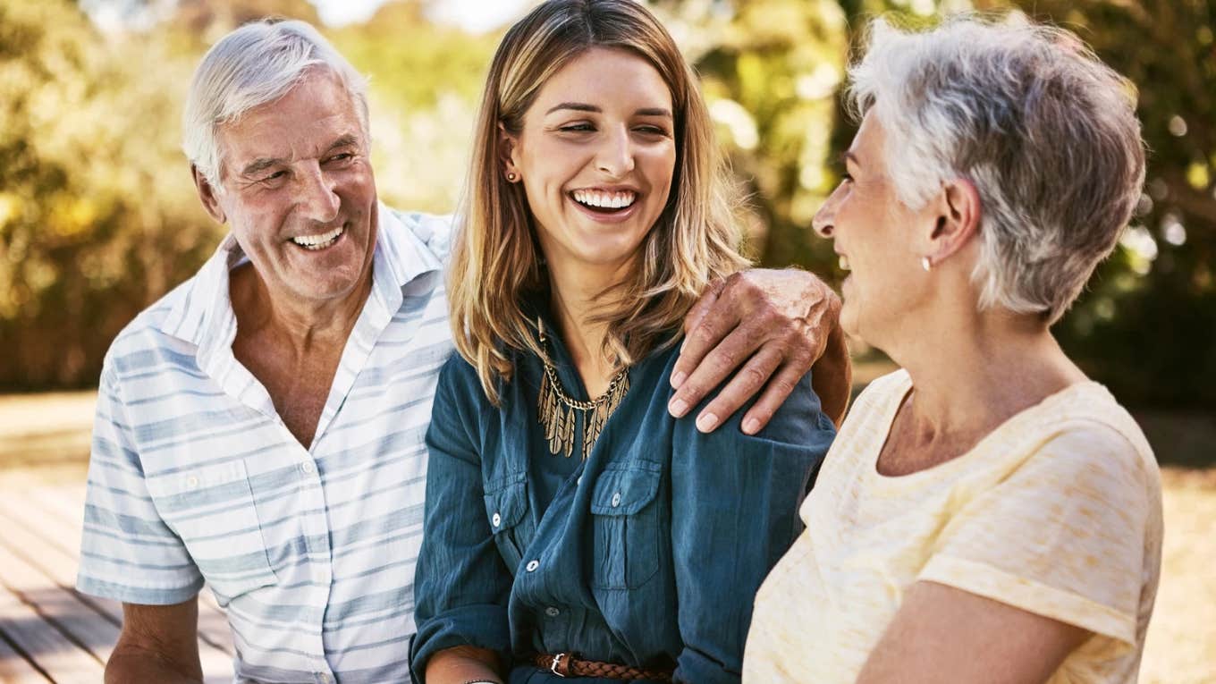 smiling daughter with happy supportive parents