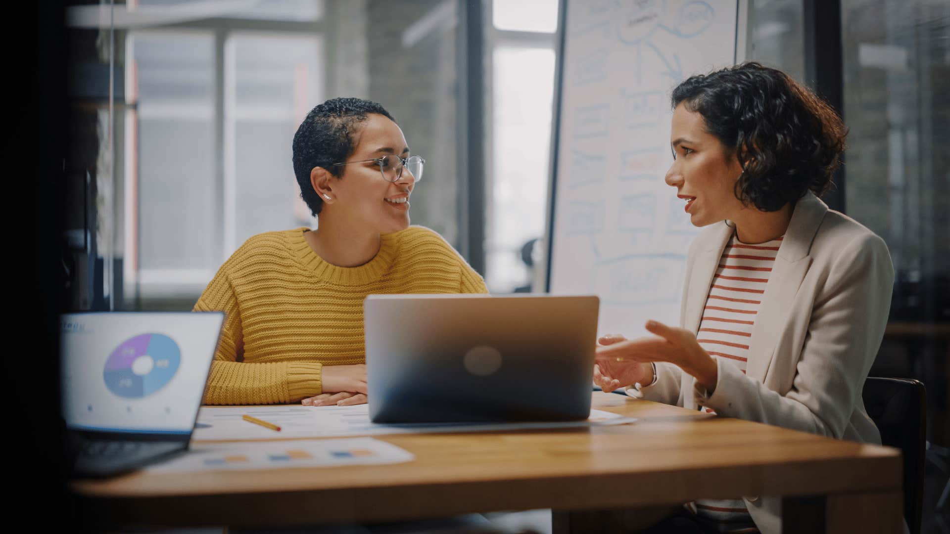 two women coworkers talking