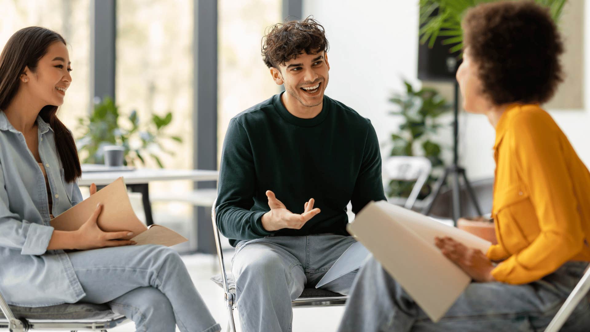 three people sitting and talking 