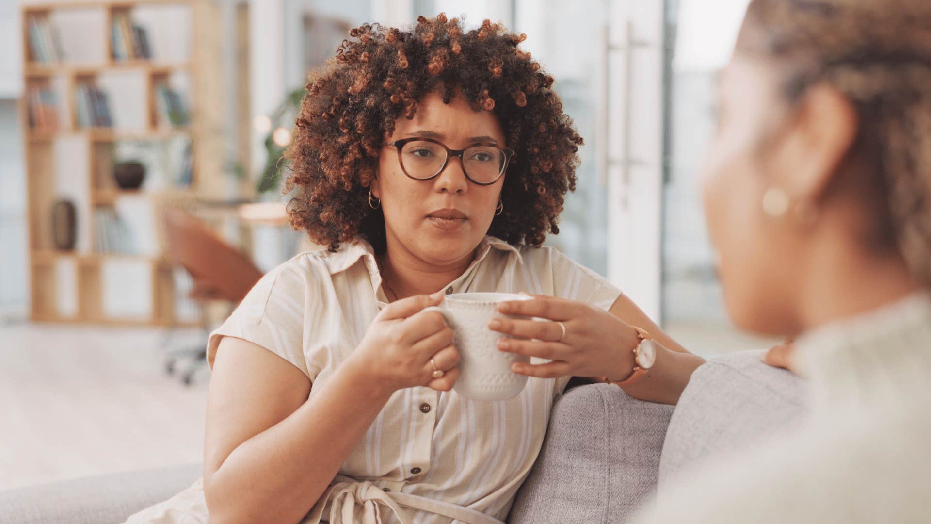 Woman talks to friend while carefully considering