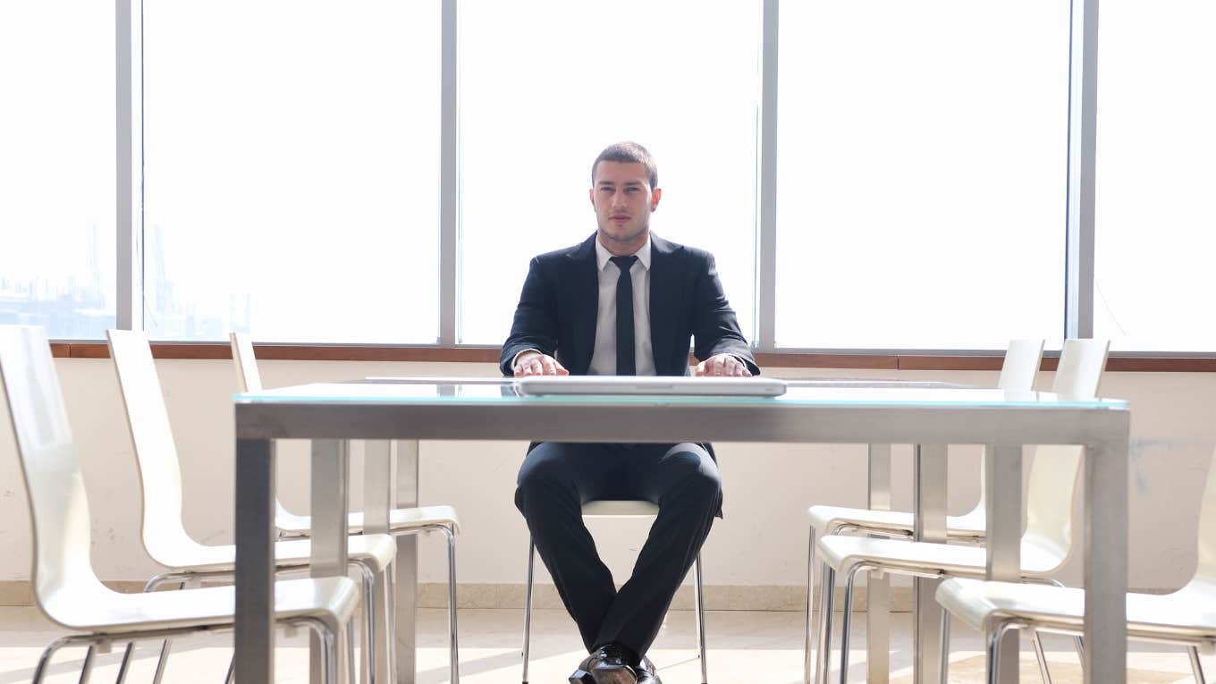 angry CEO alone in conference room