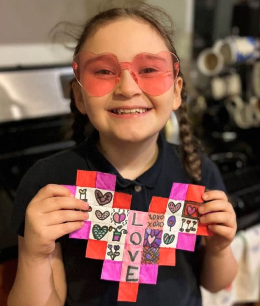 I chose not to have kids but love my niece, seen here holding a heart and smiling 