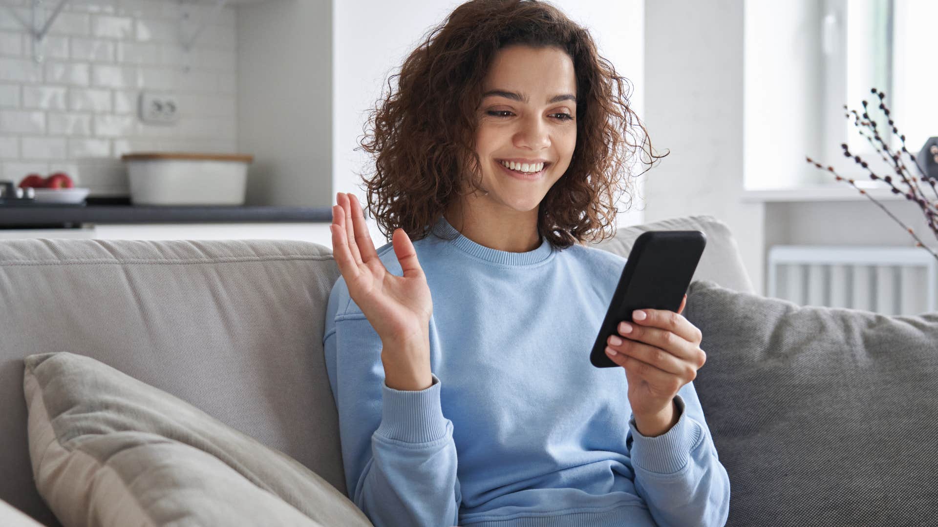 Gen Z woman smiling and talking on her phone