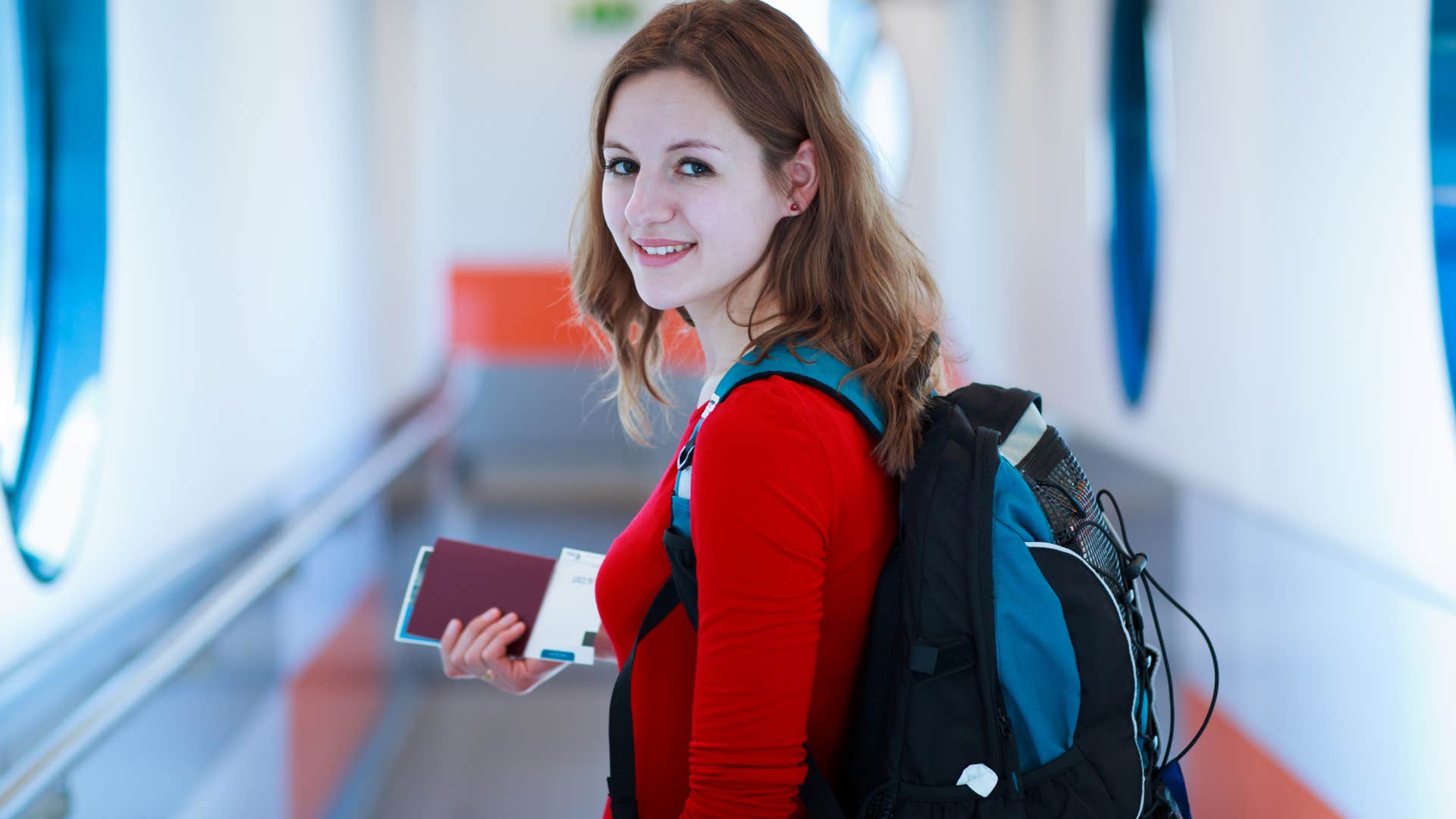 Young woman smiling while boarding an airplane