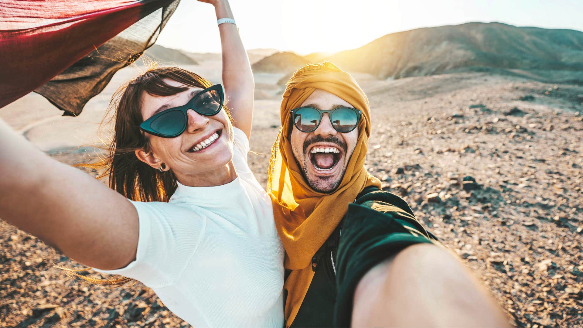 Couple smiling while taking a picture on vacation